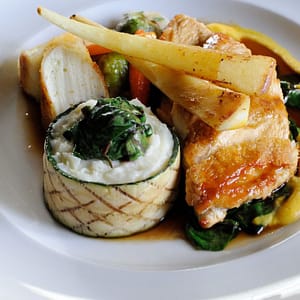 Suprême of chicken with truffled sausage, potato purée with leeks, roasted vegetables and tarragon jus